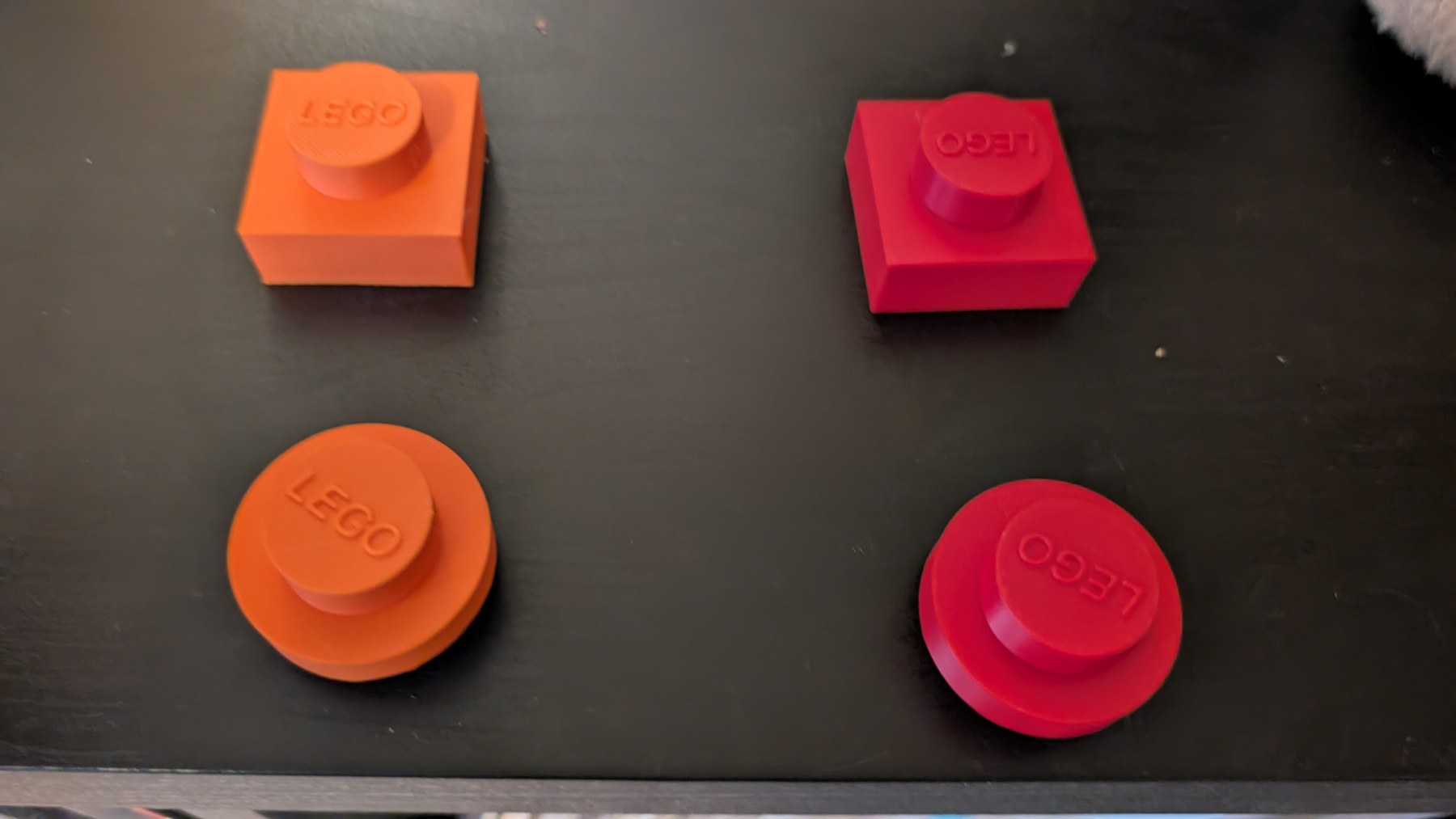 Four orange and red printed bricks in square and round shapes