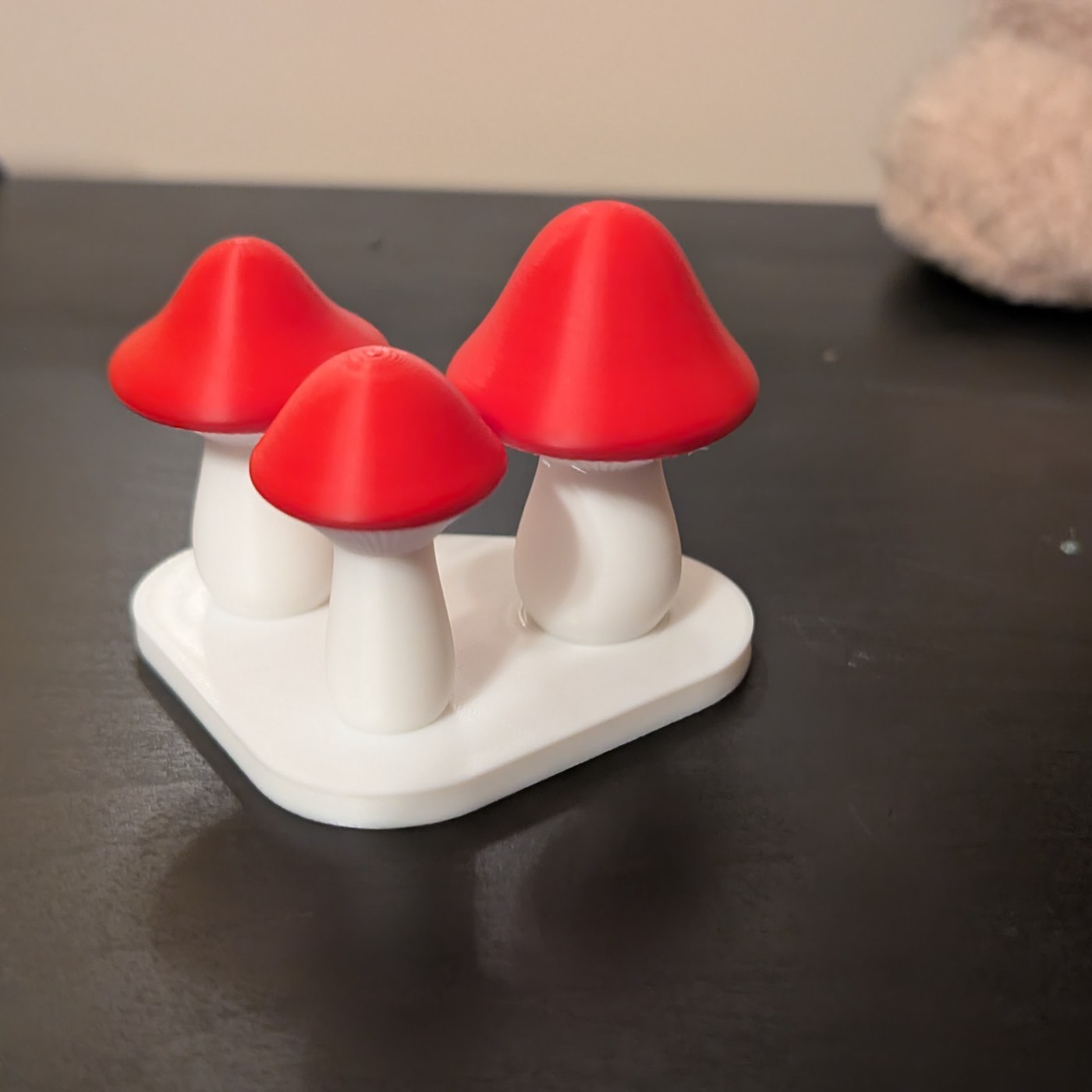 Finished Mini Mushroom Trio with red caps and white stems on a shared white base